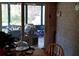 Dining area with view of sunroom and backyard through sliding glass doors at 141 Wintergreen Rd, Walterboro, SC 29488