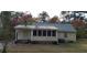 Exterior view of a house with a green metal roof and a sunroom at 141 Wintergreen Rd, Walterboro, SC 29488