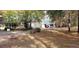Home with covered carport, driveway, and surrounding trees during autumn at 141 Wintergreen Rd, Walterboro, SC 29488