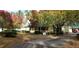 Quaint home with covered carport and driveway, set amidst trees showing fall colors at 141 Wintergreen Rd, Walterboro, SC 29488