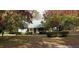 Single-story house with a front porch, surrounded by bushes and fall leaves on the lawn at 141 Wintergreen Rd, Walterboro, SC 29488
