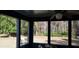 Sunroom with large windows overlooking a wooded backyard at 141 Wintergreen Rd, Walterboro, SC 29488