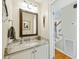 Half bath with granite countertop, white vanity, and mirror at 1434 River Front Dr, Charleston, SC 29407