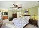 Large main bedroom with ceiling fan, ensuite bathroom, and floral bedding at 1434 River Front Dr, Charleston, SC 29407