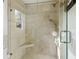 Walk-in tiled shower with glass doors and built-in seat at 1434 River Front Dr, Charleston, SC 29407