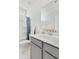 Modern bathroom with gray vanity, white countertop, and marble-look tile floor at 1445 Clay Field Trl, Summerville, SC 29485