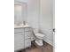 Clean and bright half-bathroom with white vanity and wood-look flooring at 1445 Clay Field Trl, Summerville, SC 29485