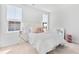Bright, airy bedroom with white bedding, two windows, and stylish accents at 1445 Clay Field Trl, Summerville, SC 29485