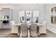 Dining room featuring a rustic table, wicker chairs, and large windows at 1445 Clay Field Trl, Summerville, SC 29485