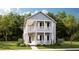 Charming two-story home with a welcoming front porch and lush landscaping at 1445 Clay Field Trl, Summerville, SC 29485
