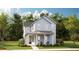 Two-story home with a covered front porch, nestled among trees at 1445 Clay Field Trl, Summerville, SC 29485