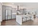Kitchen with island seating, stainless steel appliances, and grey cabinets at 1445 Clay Field Trl, Summerville, SC 29485