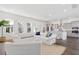 Bright living room with white furniture, large windows, and open view to kitchen at 1445 Clay Field Trl, Summerville, SC 29485