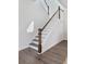 Elegant staircase with white risers and dark wood railing at 1445 Clay Field Trl, Summerville, SC 29485