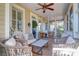 Inviting screened porch with seating area and access to the home's entrance at 1551 Ben Sawyer Blvd # 22, Mount Pleasant, SC 29464