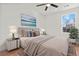 Bedroom with neutral bedding, ceiling fan, and wood-look flooring at 2042 Delaware Ave, North Charleston, SC 29405