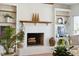 White brick fireplace with wood mantel, flanked by built-in shelves, and wood floors at 2457 Vaucluse Rd, Charleston, SC 29414