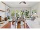 Bright sunroom with white furniture, large windows, and hardwood floors at 2457 Vaucluse Rd, Charleston, SC 29414