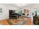 Elegant living room with a grand piano, plush seating, and an ornate rug at 2457 Vaucluse Rd, Charleston, SC 29414