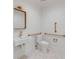 Accessible bathroom featuring white fixtures, gold accents, and safety grab bars at 278 Meeting St, Charleston, SC 29401