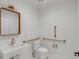 Modern accessible bathroom with tiled floor, white fixtures, gold accents, and grab bars at 278 Meeting St, Charleston, SC 29401