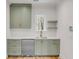 Modern kitchen with light green cabinets, stainless steel appliances, and gold hardware at 278 Meeting St, Charleston, SC 29401
