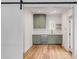 Modern kitchen featuring green cabinetry, stainless steel appliances, and white countertops at 278 Meeting St, Charleston, SC 29401