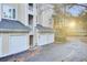 Condo building exterior with garages, balconies, and landscaping at sunset at 280 Seven Farms Dr # 203, Charleston, SC 29492