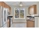 Bright kitchen with large window, wood cabinets, and stainless steel appliances at 280 Seven Farms Dr # 203, Charleston, SC 29492