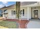 Welcoming front porch with white railing, rocking chair, and a front door at 3009 Woodington Pl, Goose Creek, SC 29445