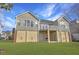 Back view of two-story home with elevated deck and grassy backyard at 359 Clayton Dr, Charleston, SC 29414