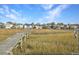 Long dock stretching over the marsh toward homes at 359 Clayton Dr, Charleston, SC 29414