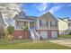 Inviting two-story home with a brick facade, double garage, and green lawn at 359 Clayton Dr, Charleston, SC 29414