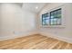 Bright, empty bedroom with large window and wood-look flooring at 48 Grove St, Charleston, SC 29403