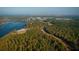 An aerial view of a community surrounded by trees and a large lake or river at 773 Opal Wing St, Moncks Corner, SC 29461