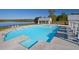 Large community pool with lounge chairs, pergola, and lake view at 773 Opal Wing St, Moncks Corner, SC 29461