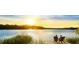 Couple enjoying sunset view from a private dock at 773 Opal Wing St, Moncks Corner, SC 29461