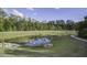 Community pond with a walking path, surrounded by trees and grass at 827 Kirby Ct, Charleston, SC 29414