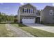 Two-story home with a brick and siding exterior, attached garage, and landscaped front yard at 827 Kirby Ct, Charleston, SC 29414