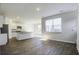 Bright kitchen with white cabinets, large windows, and wood-style flooring at 827 Kirby Ct, Charleston, SC 29414