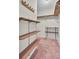 Walk-in closet with built-in wooden shelves and pink carpeted flooring at 100 -102 Sommet Blvd, Summerville, SC 29483