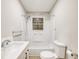 Bathroom with white tub/shower, vanity, and wood-look floor at 104 Grant St, Walterboro, SC 29488