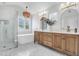 Modern bathroom featuring double vanity, soaking tub, glass shower, and hexagon tile at 1423 Brockenfelt Dr, Charleston, SC 29414