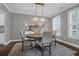 Elegant dining room featuring a round wooden table, stylish light fixture, and large windows at 1423 Brockenfelt Dr, Charleston, SC 29414