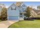 Charming blue two-story home with a welcoming front porch and landscaped yard at 1423 Brockenfelt Dr, Charleston, SC 29414