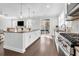 Modern kitchen with white cabinets, large island, stainless steel appliances, and hardwood floors at 1423 Brockenfelt Dr, Charleston, SC 29414