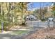 Gated entrance to a brick house with a front porch and large yard at 1695 Pierpont Avenue, Charleston, SC 29414