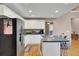 White kitchen with island, stainless steel appliances, and hardwood floors at 1695 Pierpont Avenue, Charleston, SC 29414