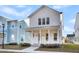 White two-story home with a front porch, landscaping, and a welcoming walkway at 206 W Respite Ln, Summerville, SC 29483