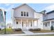 Inviting white two-story home with a covered front porch and a landscaped yard at 206 W Respite Ln, Summerville, SC 29483